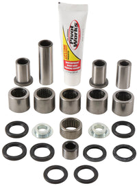 Pivot Works suspension linkage rebuild kit for Yamaha models, including bushings and bearings, on a clean work surface.