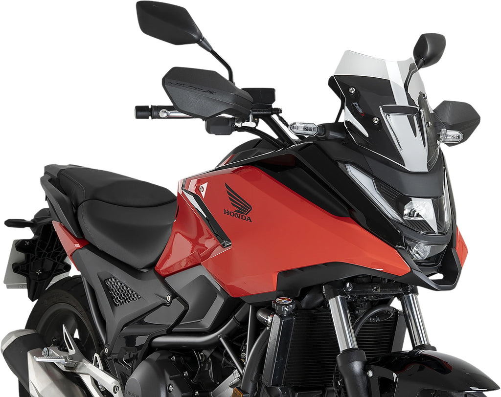 Clear PUIG Windscreen Sport windshield mounted on motorcycle, showcasing its sleek design and transparent protective surface.