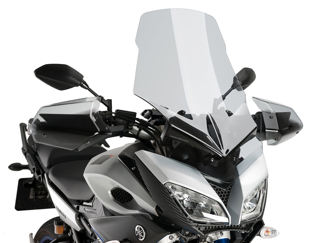 Clear PUIG Windscreen Touring windshield mounted on motorcycle, showcasing its aerodynamic design and transparent material.