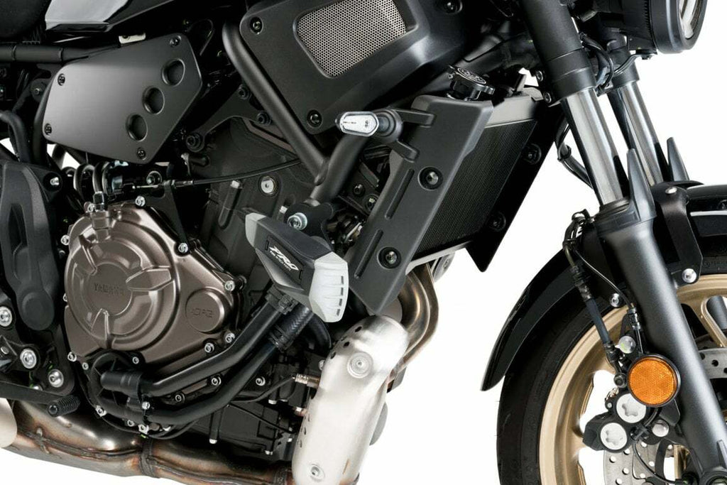 PUIG Frame Sliders Pro 2.0 in black for motorcycle protection, mounted on bike frame with visible branding and sleek design