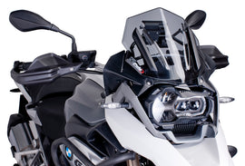 PUIG Racing Light Windscreen for motorcycle, clear windshield with aerodynamic design, mounted on bike with racing style.
