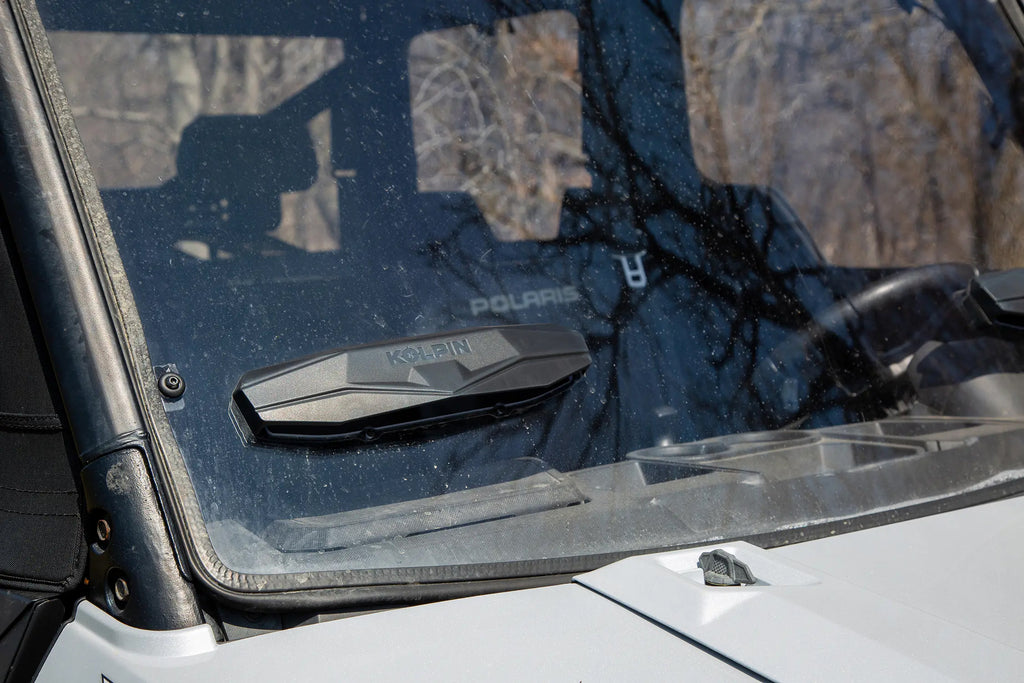 Kolpin Poly Front Windshield for ATV, full fixed vented design with clear poly material, displaying the windshield's shape and mounting edges.