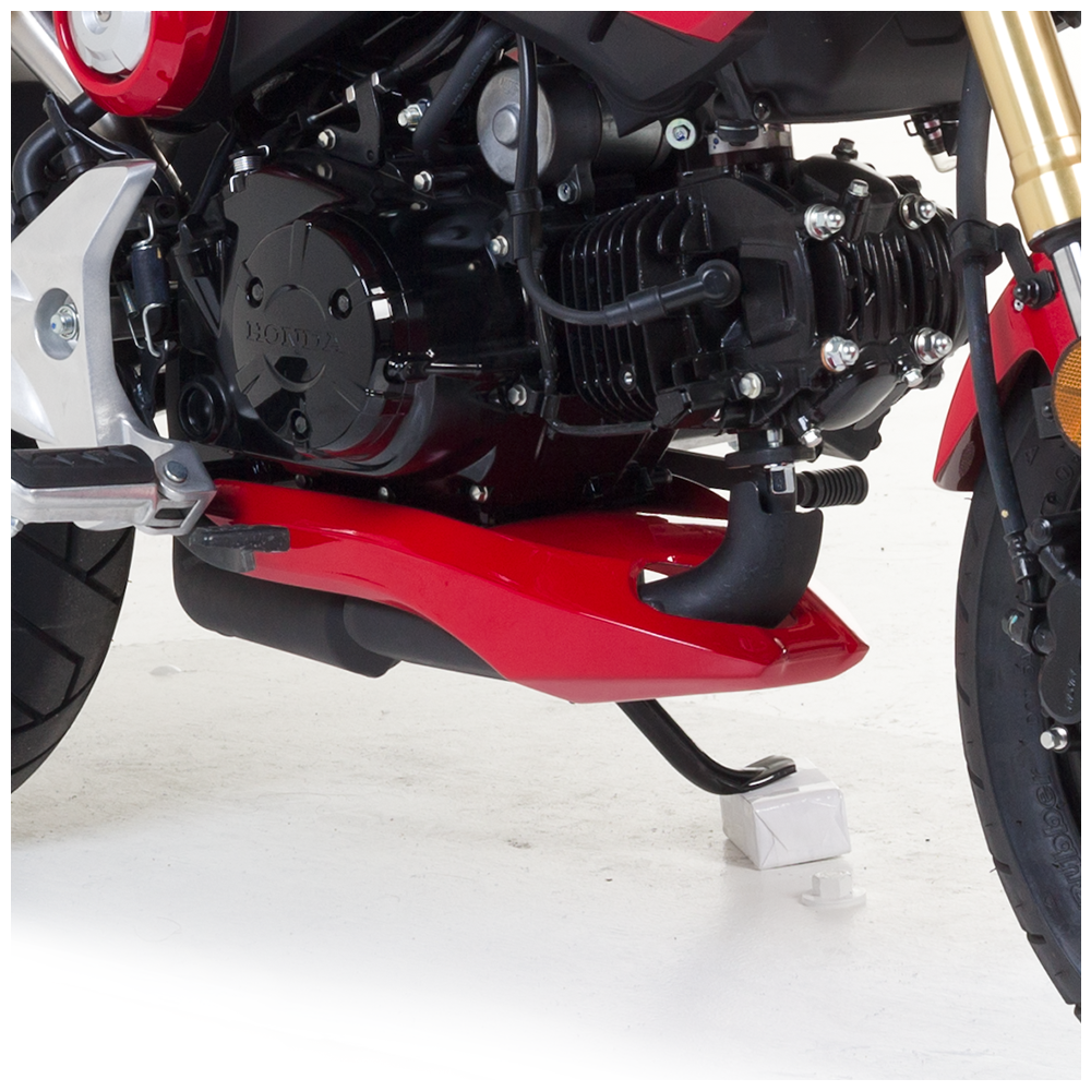 Unpainted Hotbodies Racing Grom body part lower fairing with smooth curves and mounting points, designed for motorcycle customization.