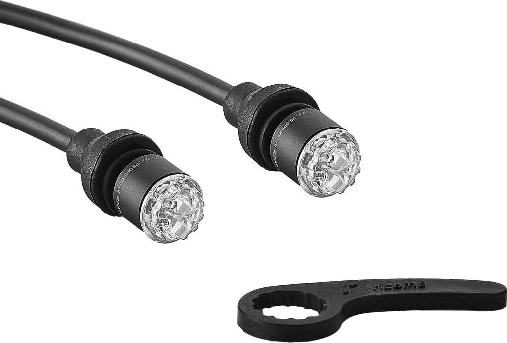 Pair of RIZOMA matte black turn signal light units for motorcycle or vehicle, with clear lenses and mounting brackets.