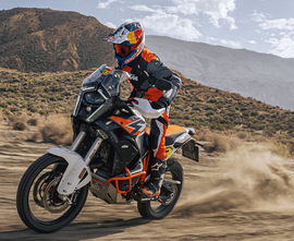 RAPTOR titanium foot pegs for KTM motorcycle, durable foot controls with a sleek metallic finish and textured surface for grip.