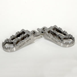 IMS Core Enduro Footpegs for motorcycle foot controls, featuring durable metal construction and textured surface for grip.