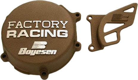 Boyesen Factory Racing magnesium ignition cover for bikes, showcasing sleek silver finish with detailed branding and precise engineering.