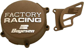 Boyesen Factory Racing magnesium ignition cover for bikes, showcasing sleek silver finish with detailed branding and precise engineering.