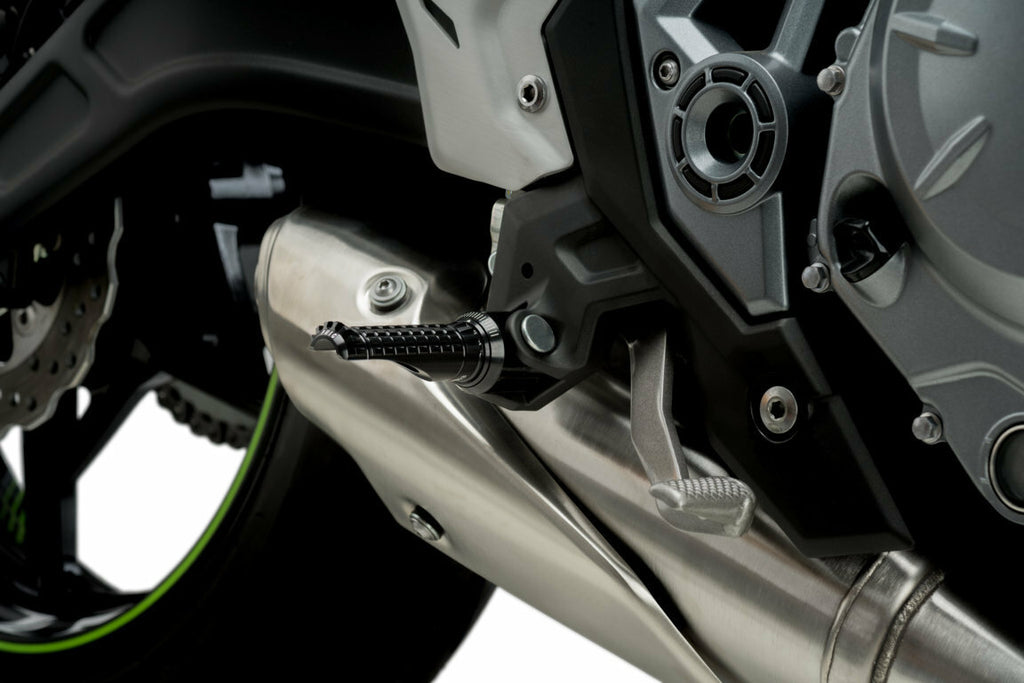 Black PUIG R-Fighter footpegs for motorcycle foot controls, shown on a bike with a sleek, durable design.
