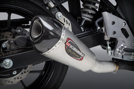 Yoshimura Street Alpha-T slip-on exhaust for motorcycles, featuring stainless steel and carbon fiber components, mounted on a bike.