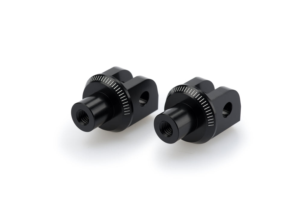 PUIG Footpeg Adapter for motorcycle foot controls, black metal with mounting hardware visible in the image.