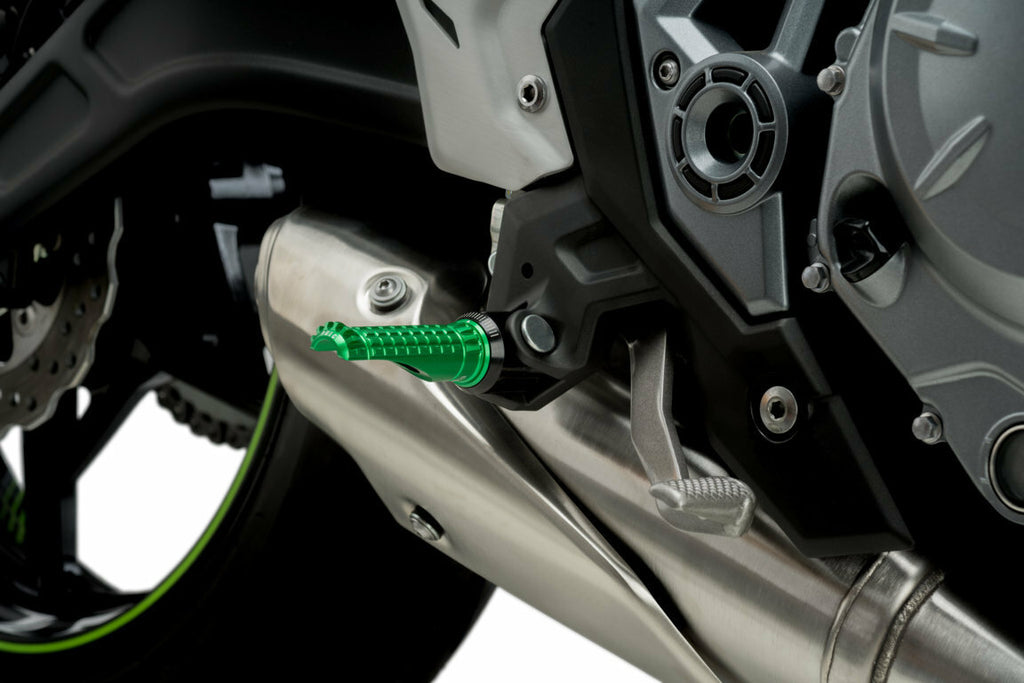 PUIG R-Fighter green motorcycle footpegs for foot controls, showing detailed green metal footrest with textured surface.