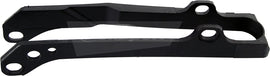 Polisport Plastics black drive chain slider 64-0551 for motorcycle, shown mounted on the chain drive system.