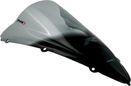 PUIG racing smoke windscreen for motorcycle, lightweight and aerodynamic, with tinted smoked finish, designed for high-performance riding.
