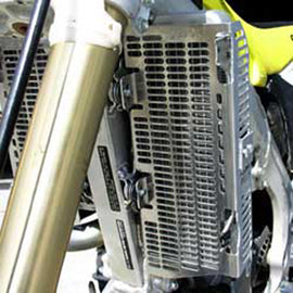 Devol Aluminum Radiator Guard 60-5414 for off-road vehicles, showing the durable metal protective grille in a rugged environment.
