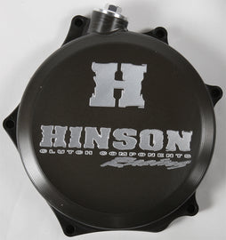 Hinson clutch cover for Honda RMZ250 engine, black metal with detailed branding and mounting holes visible.