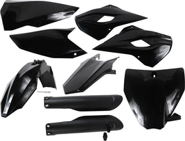 Black Acerbis plastic kit with various molded plastic parts arranged on a surface.