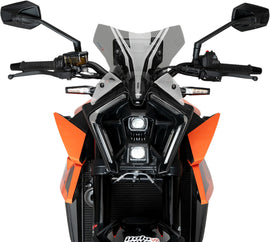 PUIG Naked New Gen Sport Smoke Windscreen for KTM motorcycle, showcasing sleek, tinted windshield with mounting brackets.