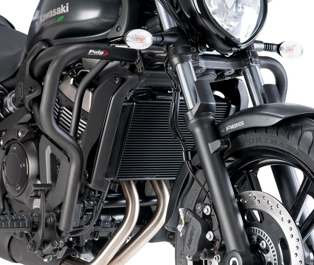 Black PUIG engine guards for Kawasaki motorcycle, body protection with sturdy metal construction and mounting brackets visible.