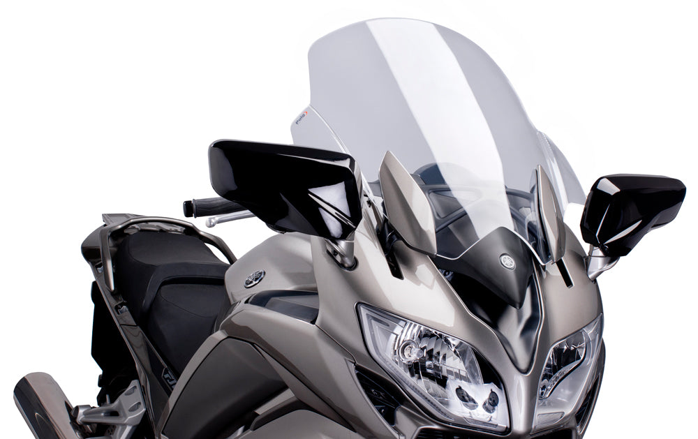 Clear PUIG touring windscreen for motorcycle, showing the transparent windscreen with mounting brackets and sleek design.