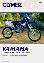 Clymer Yamaha YZ/Wr250f repair manual open to engine section, showing detailed diagrams and instructions for motorcycle maintenance.