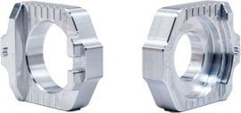 WORKS Axle Blocks Elite KTM/Hus drive accessories, showing sturdy black aluminum blocks with precise fit for motorcycle wheel axles.