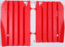 Red Polisport Plastics radiator louvers for motorcycle radiators, 64-56515, shown on a motorcycle engine.