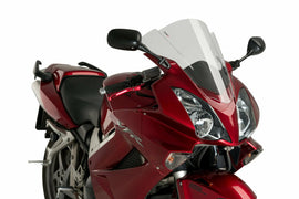 PUIG racing smoke windshield for motorcycle, clear and aerodynamic, designed to reduce wind and windblast for rider comfort.