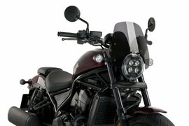 PUIG Nng Sport dark smoke motorcycle windshield mounted on a bike, showcasing aerodynamic design and tinted finish.