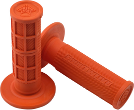 Orange Pee Wee or Pit Bike mini grips 7/8 inch by FOUR TWELVE, showing textured rubber grips on a motorcycle handlebar.