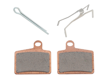 Load image into Gallery viewer, SP1 full metal brake pads for AC vehicle, showing the durable brake components with detailed metal backing and friction surface.