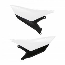 Polisport Plastics white side number plates for off-road bikes, with mounting holes and branding details visible in the image.