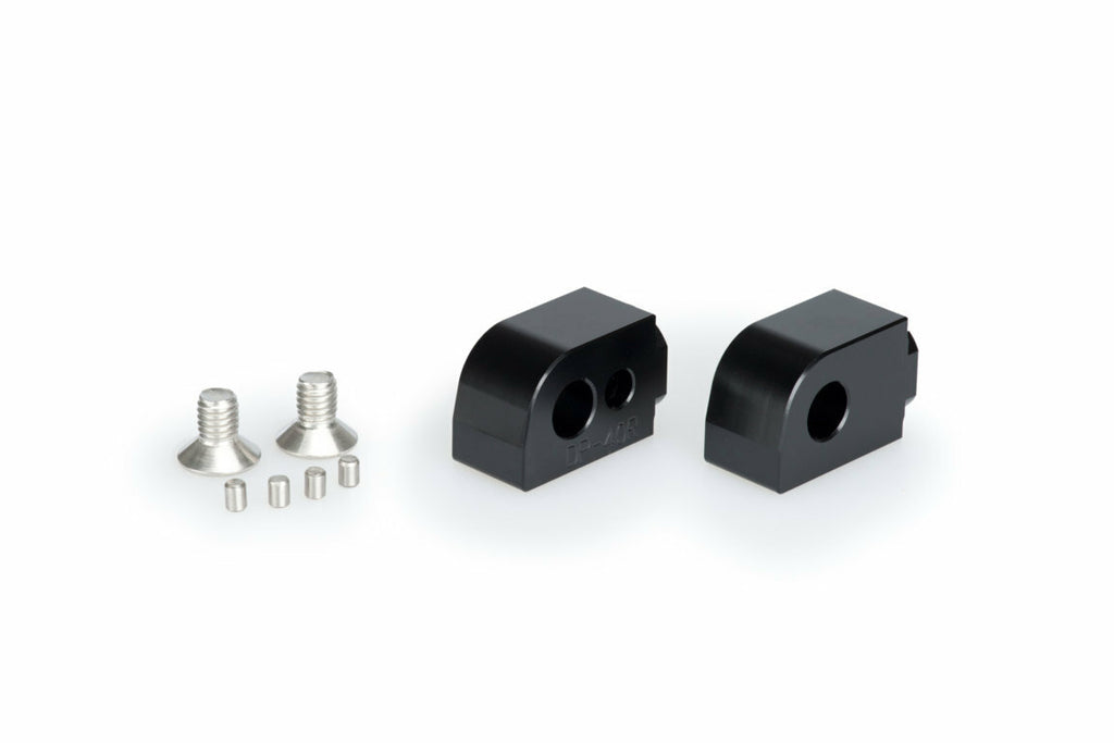 Black PUIG passenger footpeg adaptor for Suzuki motorcycle, designed to enhance foot control comfort and style.