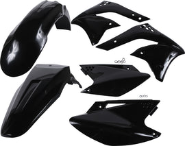 Acerbis black plastic kit for motorcycle, featuring various plastic panels and parts laid out on a white background.
