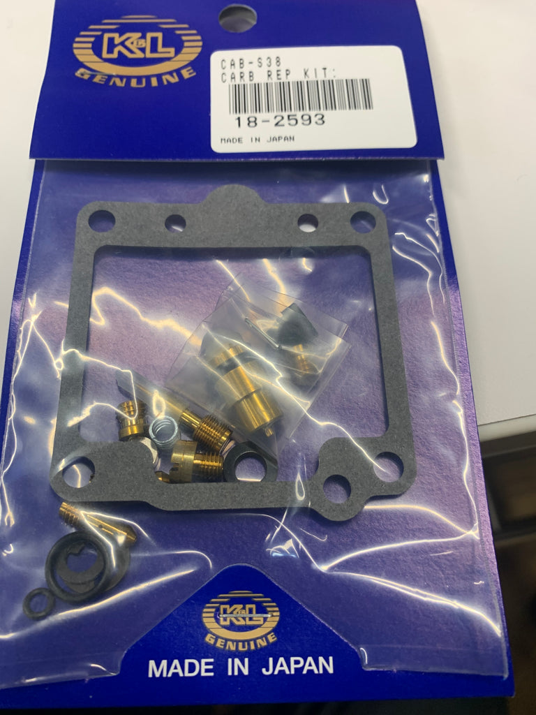 K&L Carb Repair Kit with parts for motorcycle carburetion, including gaskets and seals, displayed on a white background.