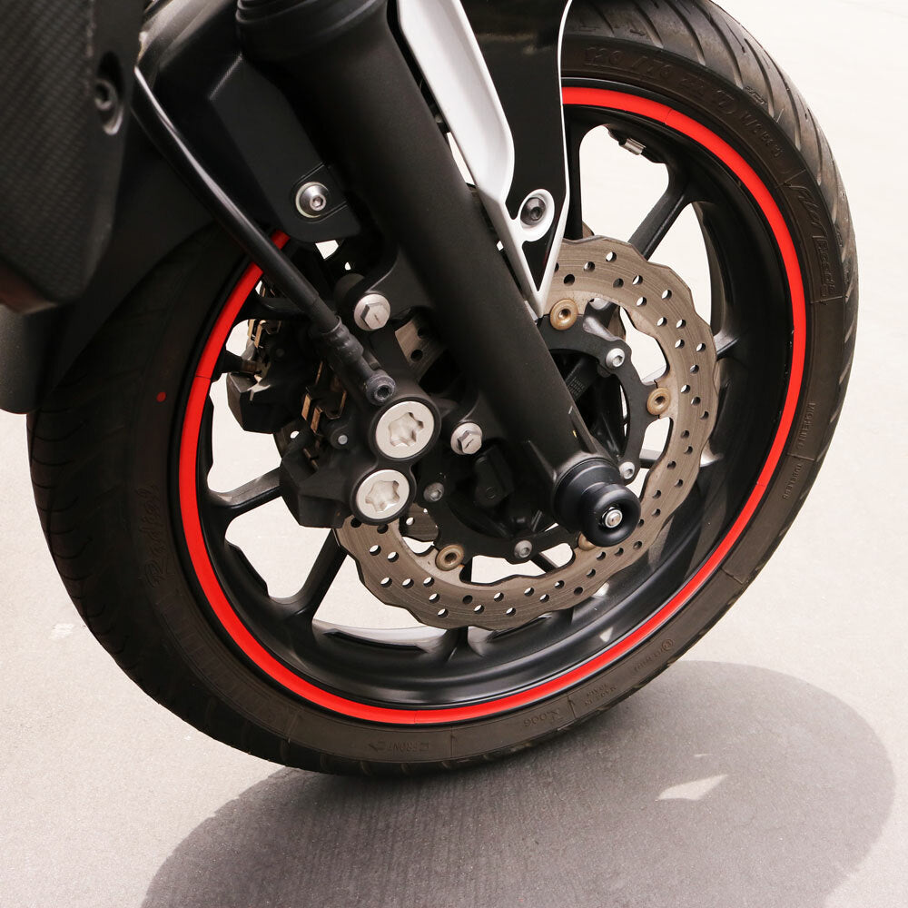 Black Shogun Industries front axle sliders for motorcycles, mounted on the vehicle's body for protection and style.