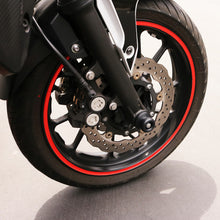 Load image into Gallery viewer, Black Shogun Industries front axle sliders for motorcycles, mounted on the vehicle's body for protection and style.