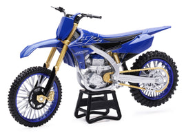 Detail of New Ray Toys 1:12 scale Yamaha YZ450F dirt bike accessory with realistic features and vibrant yellow and black colors.