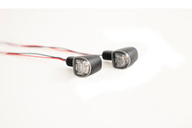 Koso North America LED turn signals and brake light pair, amber and red, mounted on a vehicle for enhanced visibility.
