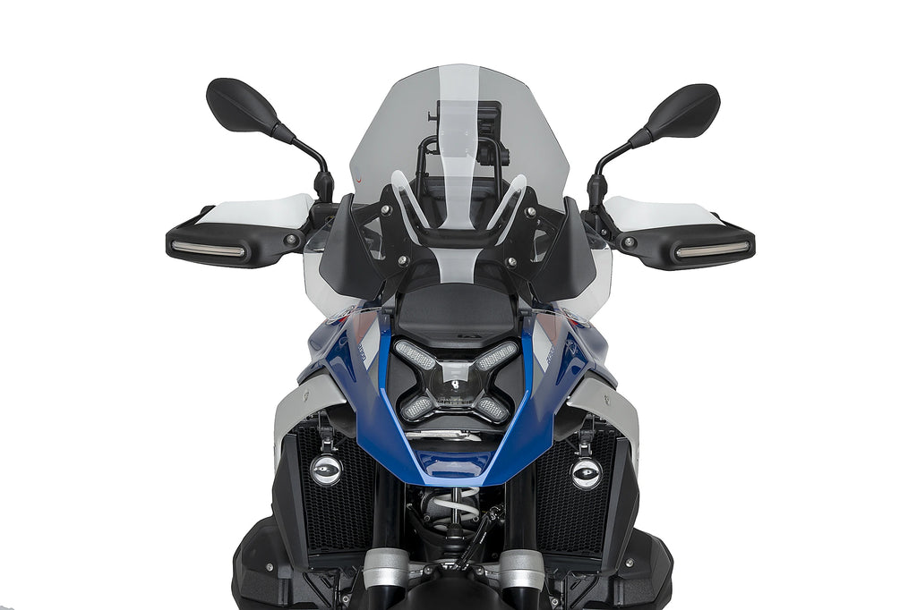 PUIG touring smoke windscreen for BMW motorcycle, shows clear tinted shield with mounting edges and reflective finish.