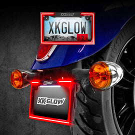 XK Glow license plate frame light with turn signal in chrome finish, featuring integrated LED lighting and signal indicators.