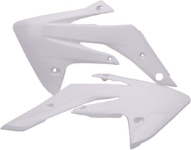 White Acerbis radiator shrouds with black accents, designed for motorcycle cooling system, shown from a side view.