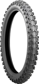 Bridgestone Battlecross X31 front motorcycle tire 90/100-21 bias Tt tread pattern on black rubber with sidewall branding.