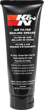 Load image into Gallery viewer, K&amp;N Sealing Grease 6oz container, a black tube with white and red branding, designed for sealing and lubricating automotive parts.