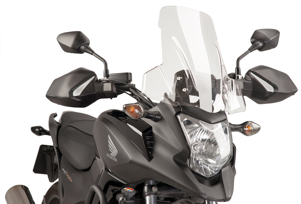 Clear Puig touring motorcycle windshield, windscreen with aerodynamic design, mounted on a motorcycle for enhanced rider protection.