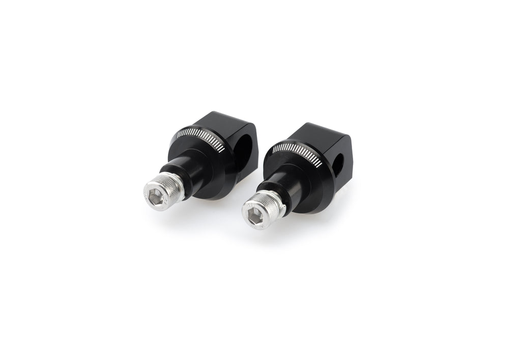 Black PUIG footpeg adapter for Kawasaki motorcycle, part of the foot controls system, with mounting hardware visible.
