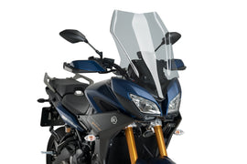 PUIG touring smoked motorcycle windscreen with aerodynamic design and tinted finish, mounted on a motorcycle.