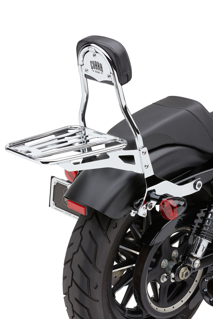 Black Cobra removable luggage rack for motorcycles, shown mounted on bike with sturdy metal construction and secure attachment points.