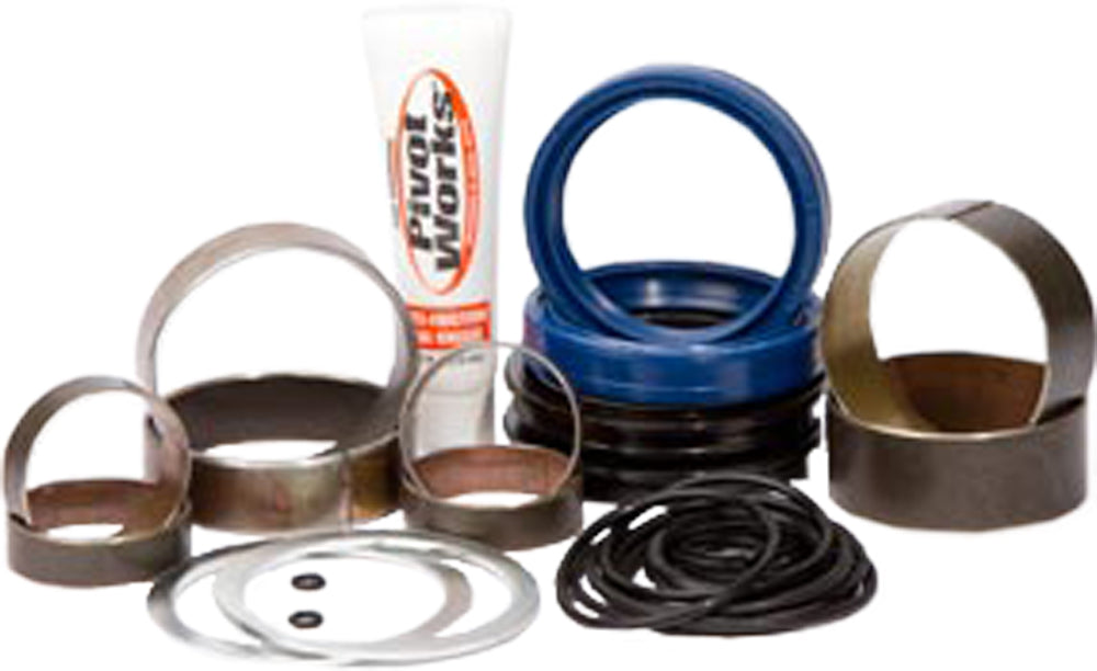 Pivot Works suspension seal and bushing kit for forks, showing various seals and bushings laid out on a white background.