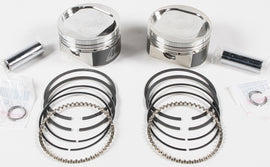 Wiseco V-Twin piston kit with multiple pistons and components for motorcycle engine rebuild, assembled on a white background.